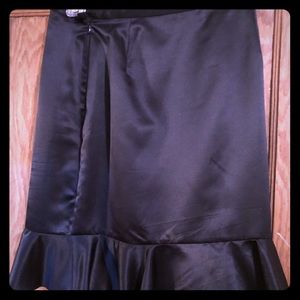 Black satin skirt with a ruffle at the bottom.